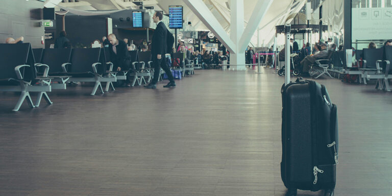 Unattended suitcase in the middle of a populated airport terminal