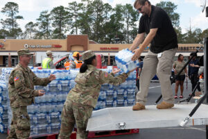 U.S. Army Soldiers with the Augusta-based 878th Engineer Battalion, 648th Maneuver Enhancement Brigade, Georgia Army National Guard, partner with Georgia State Defense Force personnel to unload cases of water during a point of distribution (POD) mission in Augusta, Georgia, Sept. 30, 2024. The Georgia National Guard has mobilized to provide response and recovery support to areas in the state impacted by Hurricane Helene. At the direction of the Governor and through The Georgia Emergency Management and Homeland Security Agency (GEMA/HS), the Georgia National Guard will continue to partner local, state, and federal entities in this effort. (U.S. Army National Guard photo by Spc. Ayanna Tillman)