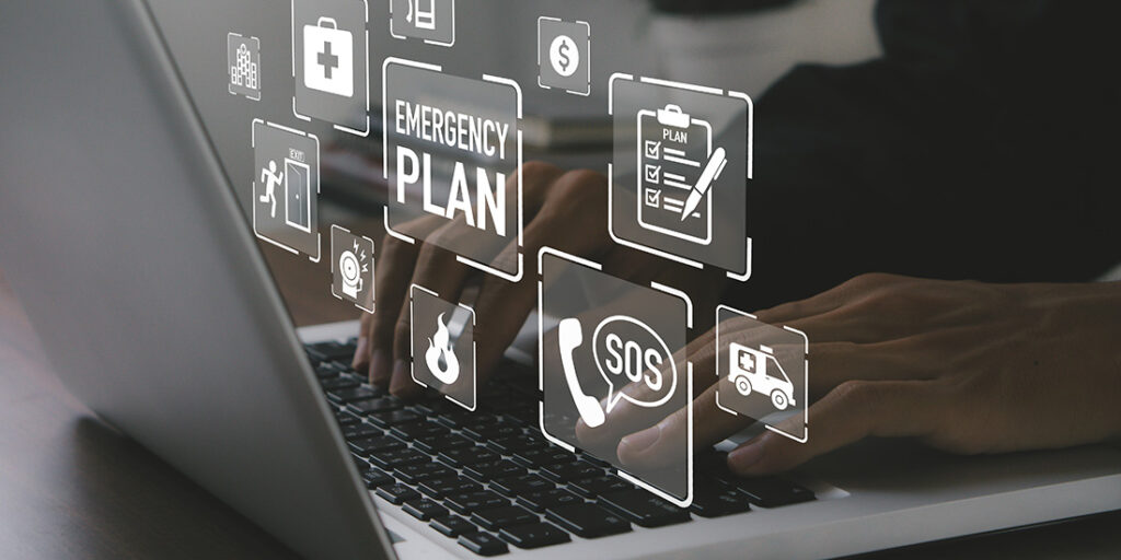 floating emergency concept buttons above laptop keyboard, hand on keyboard
